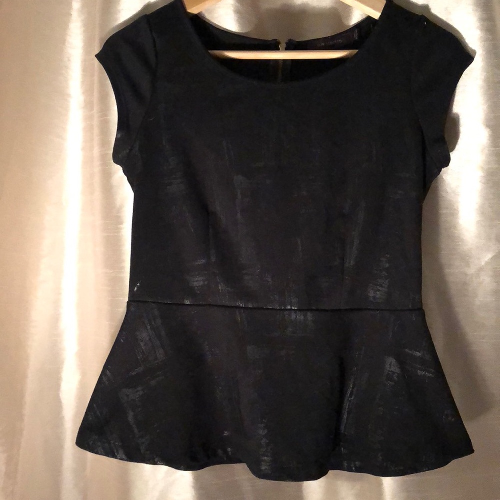 Black peplum top with gold zipper detail